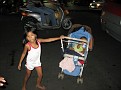 This little girl pushing a baby in a stroller in the busy streets of Saigon is selling gum.
